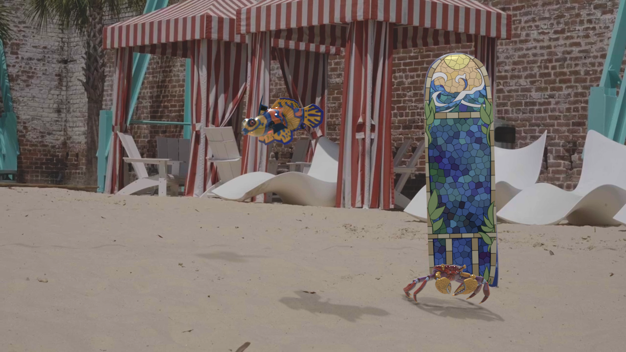 A picture of a skateboard deck on a sandy beach, with a CG glass fish and crab in front of it.